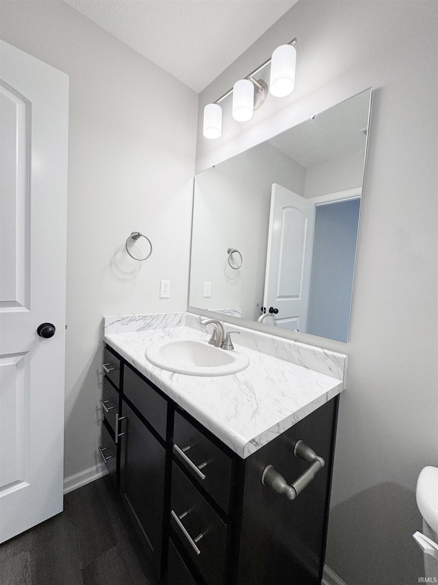 14812 Verona Lakes Psge, Fort Wayne, IN 46814 - half bathroom featuring vanity, baseboards, and wood finished floors