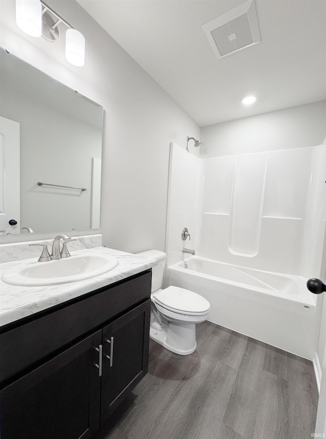 14812 Verona Lakes Psge, Fort Wayne, IN 46814 - full bathroom featuring wood finished floors, vanity, toilet, and washtub / shower combination