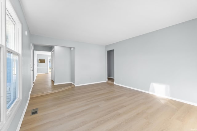 empty room with light hardwood / wood-style flooring