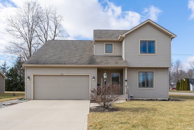 view of front of property featuring a garage and a front lawn