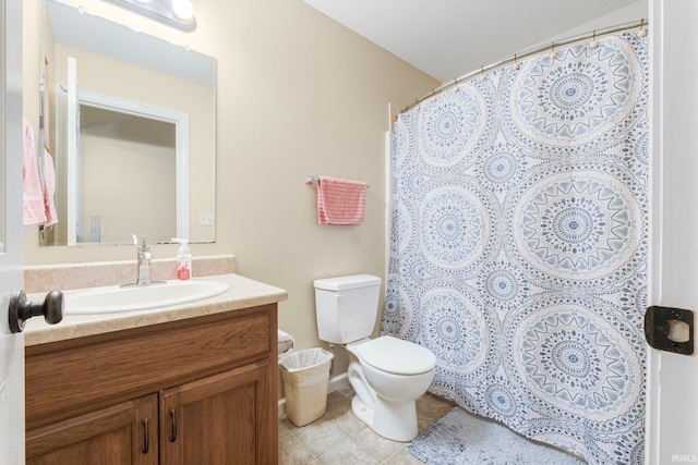 bathroom featuring vanity, tile patterned floors, and toilet