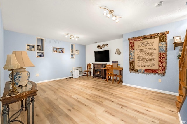 living area featuring track lighting and light wood-type flooring