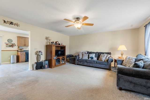 carpeted living room with ceiling fan