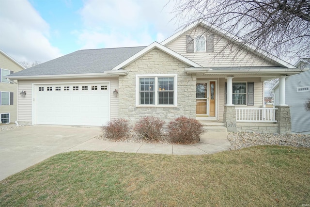 craftsman-style home with a garage, covered porch, and a front lawn