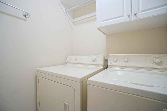 laundry area featuring cabinets and washer and clothes dryer