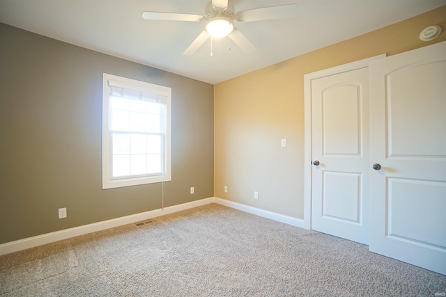 unfurnished bedroom featuring ceiling fan and carpet flooring