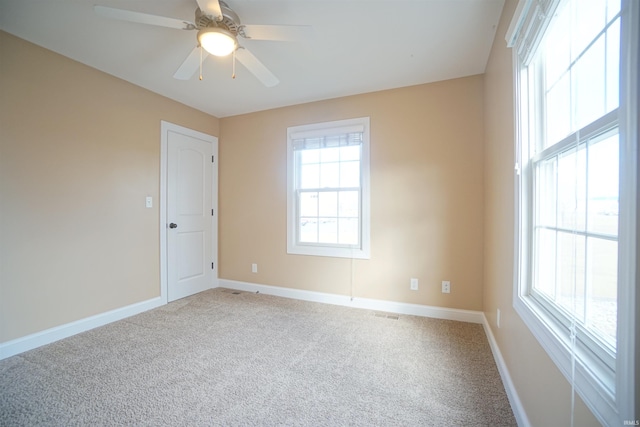 spare room featuring carpet floors and ceiling fan