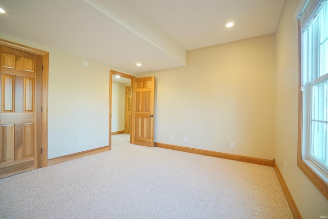 unfurnished room with light colored carpet