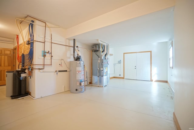 garage featuring heating unit and gas water heater