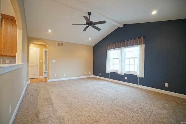 empty room with vaulted ceiling with beams, light carpet, and ceiling fan