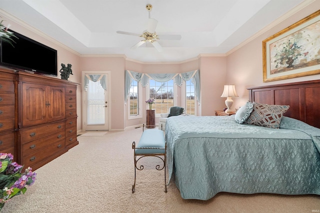 carpeted bedroom featuring a raised ceiling, ornamental molding, access to outside, and ceiling fan