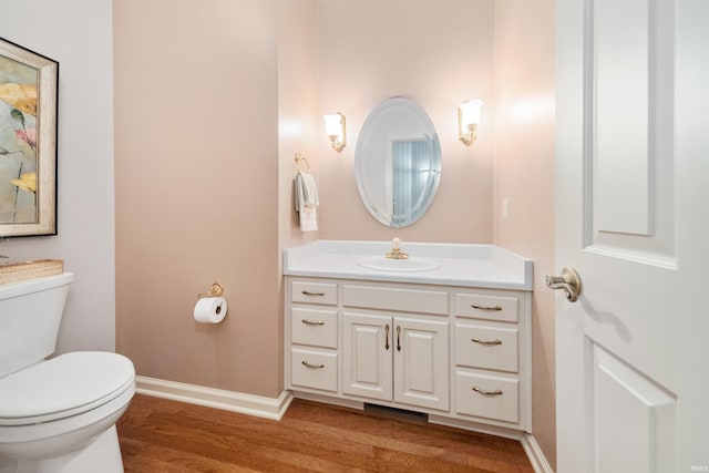 bathroom with vanity, hardwood / wood-style floors, and toilet