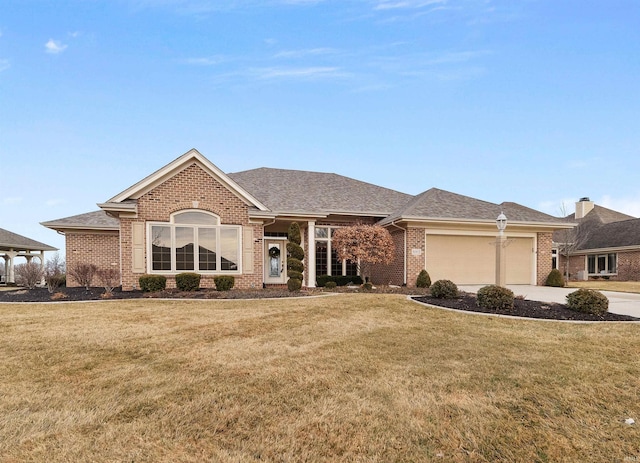 ranch-style home featuring a garage and a front lawn