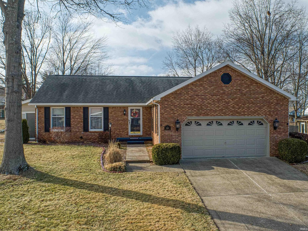 single story home featuring a garage and a front yard