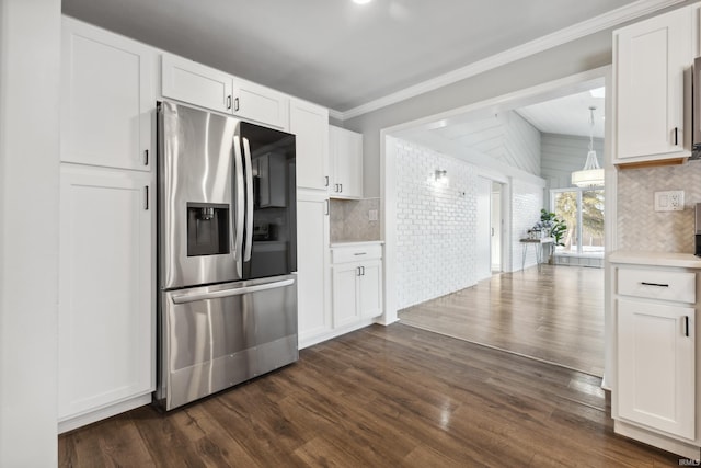 kitchen featuring dark hardwood / wood-style floors, white cabinets, backsplash, ornamental molding, and stainless steel refrigerator with ice dispenser