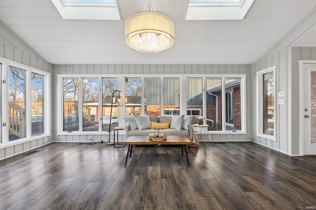 unfurnished sunroom featuring an inviting chandelier and a skylight