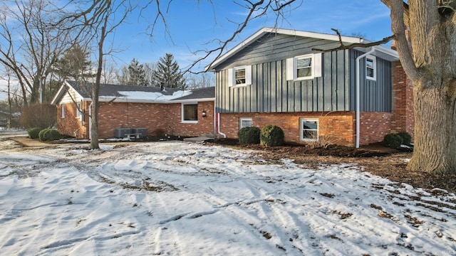 view of snow covered exterior with central air condition unit