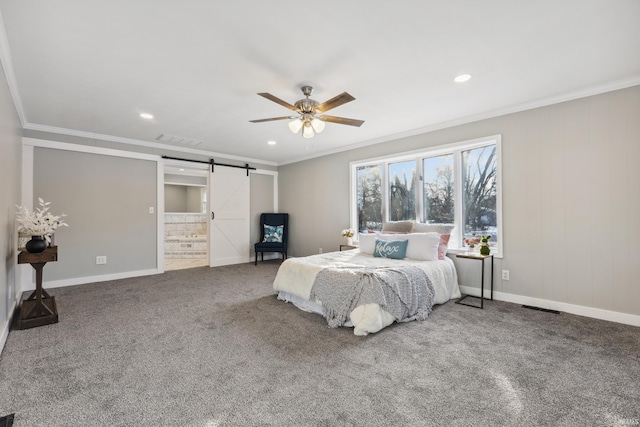 bedroom with crown molding, a barn door, carpet flooring, and connected bathroom