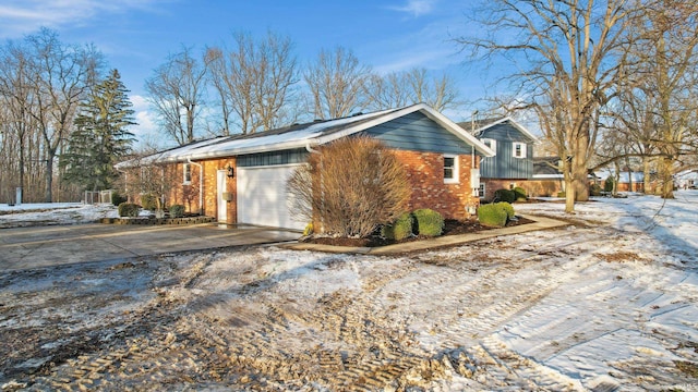 view of snowy exterior with a garage