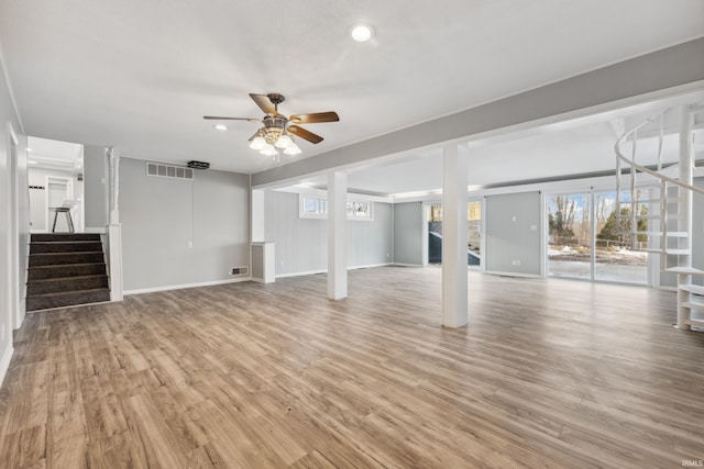 basement with ceiling fan and light wood-type flooring