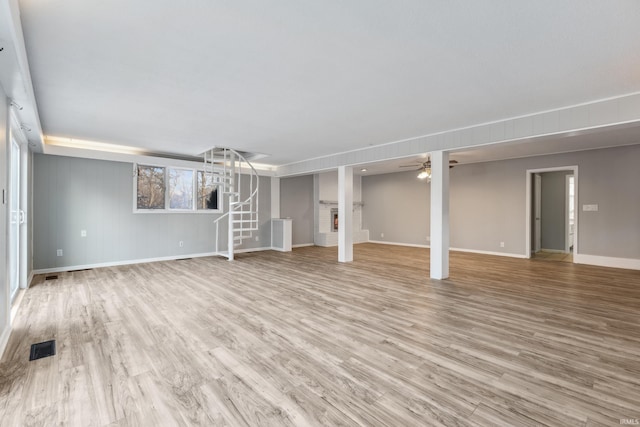 unfurnished living room featuring light hardwood / wood-style flooring and ceiling fan