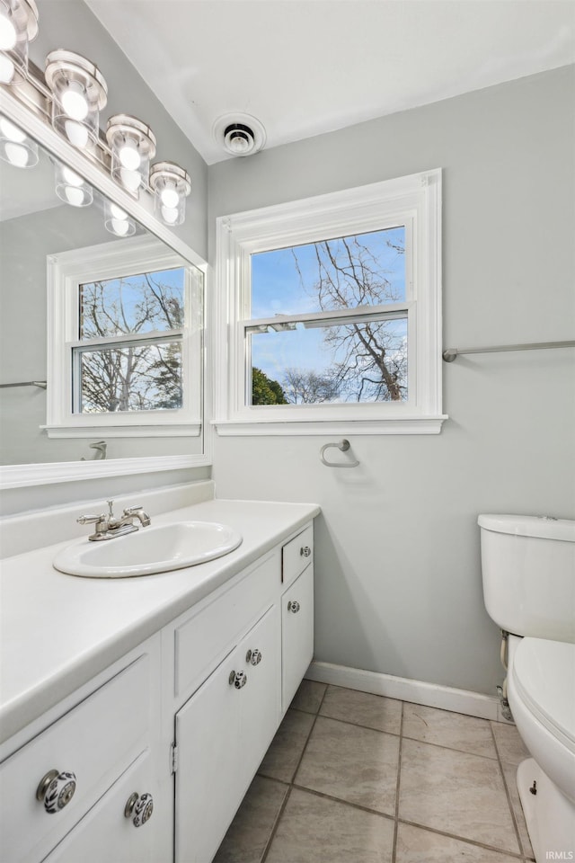 bathroom with vanity, tile patterned flooring, and toilet