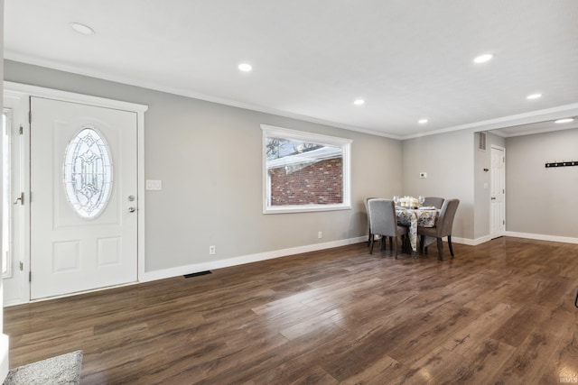 unfurnished dining area with ornamental molding and dark hardwood / wood-style floors