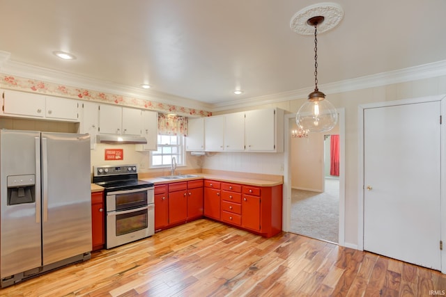 kitchen featuring stainless steel appliances, white cabinetry, hanging light fixtures, and sink