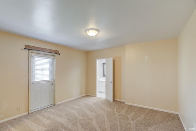 unfurnished room featuring light colored carpet