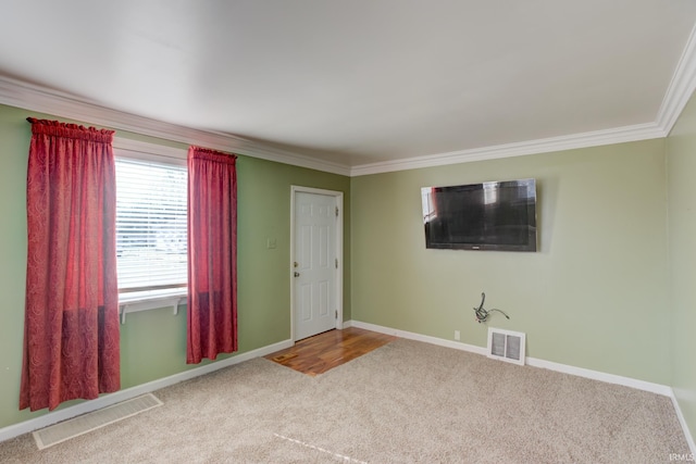 interior space featuring ornamental molding and carpet floors