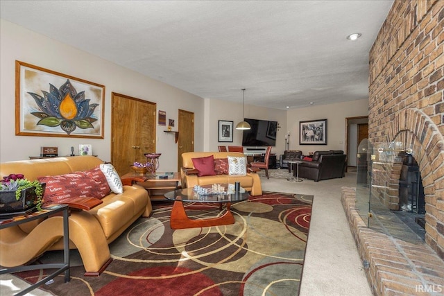 carpeted living room with a fireplace and a textured ceiling