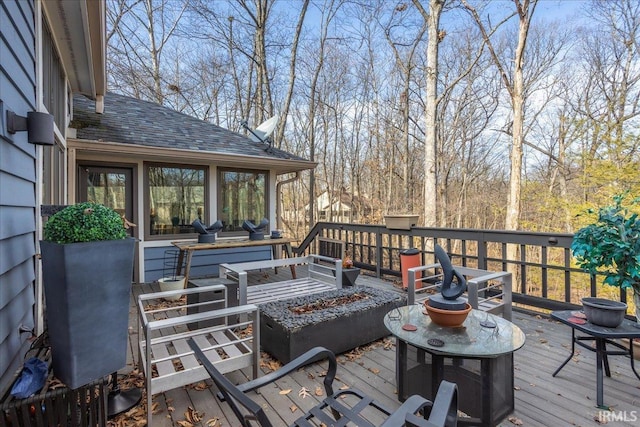 wooden terrace with a fire pit