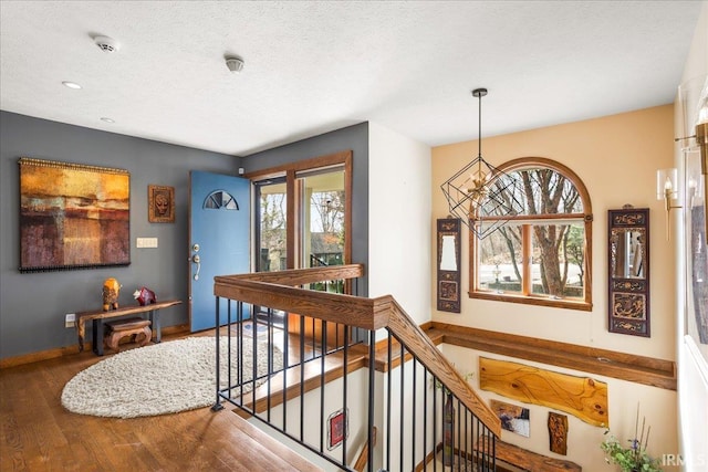 corridor featuring hardwood / wood-style floors and a textured ceiling