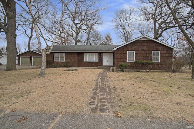 ranch-style home featuring an outbuilding and a garage