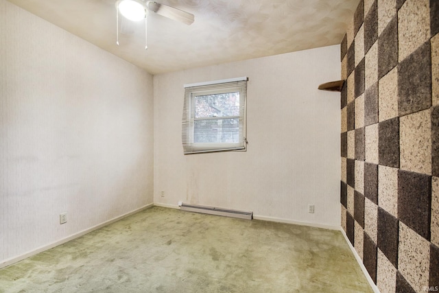 empty room with ceiling fan, carpet, and a baseboard heating unit