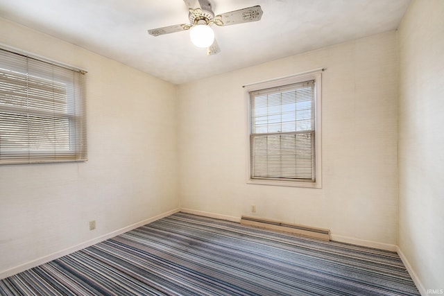 empty room featuring ceiling fan, a baseboard heating unit, and dark colored carpet