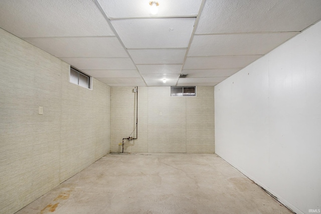 basement featuring a paneled ceiling