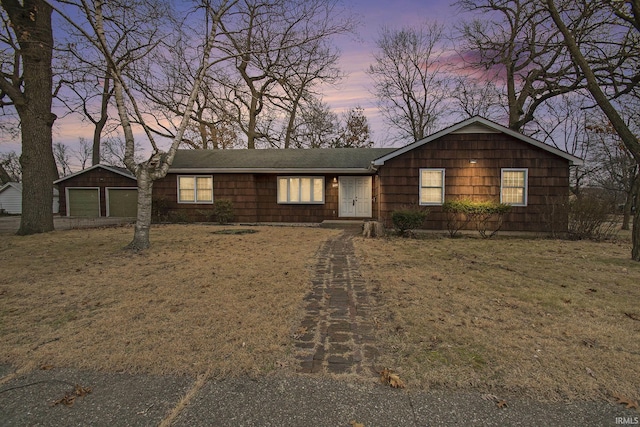 single story home featuring an outbuilding and a garage