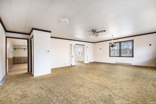 carpeted spare room featuring a baseboard radiator, ornamental molding, and ceiling fan with notable chandelier