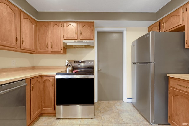 kitchen featuring light tile patterned floors and stainless steel appliances