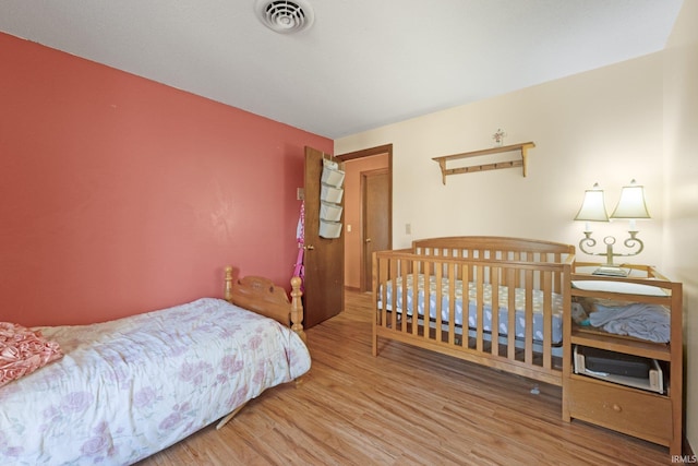 bedroom with hardwood / wood-style flooring