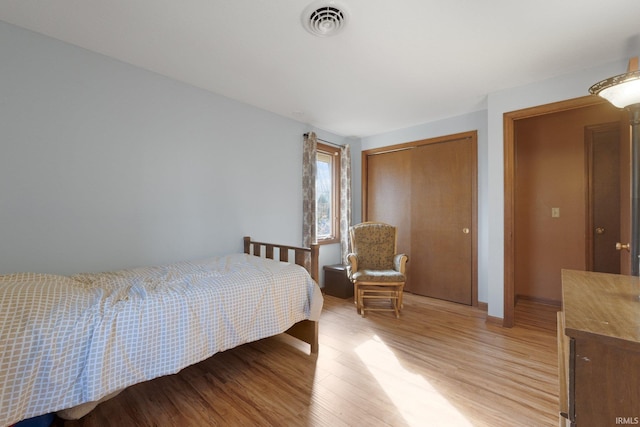 bedroom with a closet and light wood-type flooring