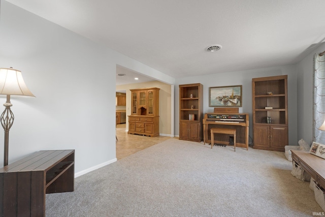 interior space with light carpet and built in shelves