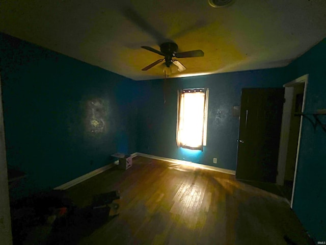 unfurnished bedroom featuring hardwood / wood-style floors and ceiling fan