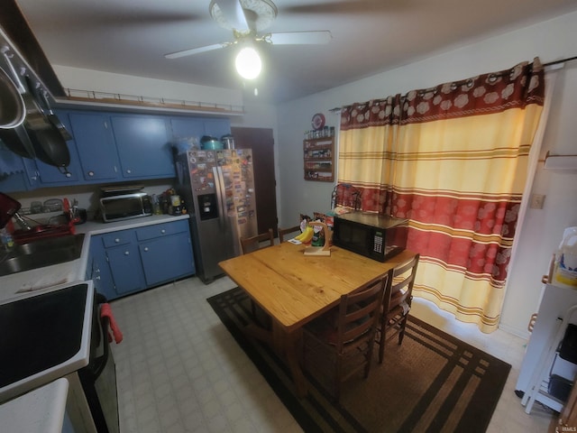 dining area featuring sink and ceiling fan