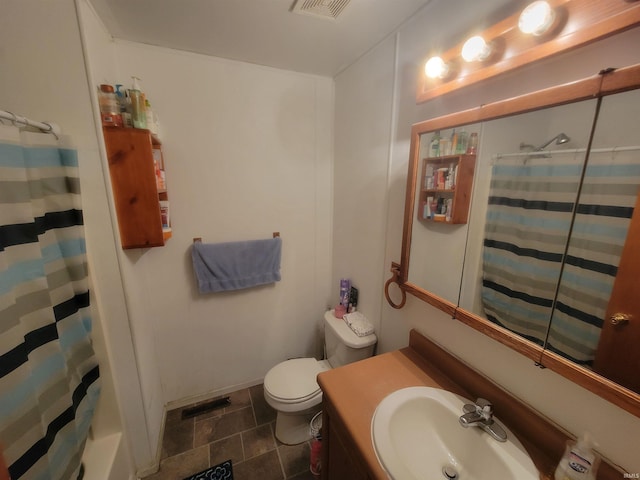 full bathroom featuring sink, shower / tub combo, and toilet