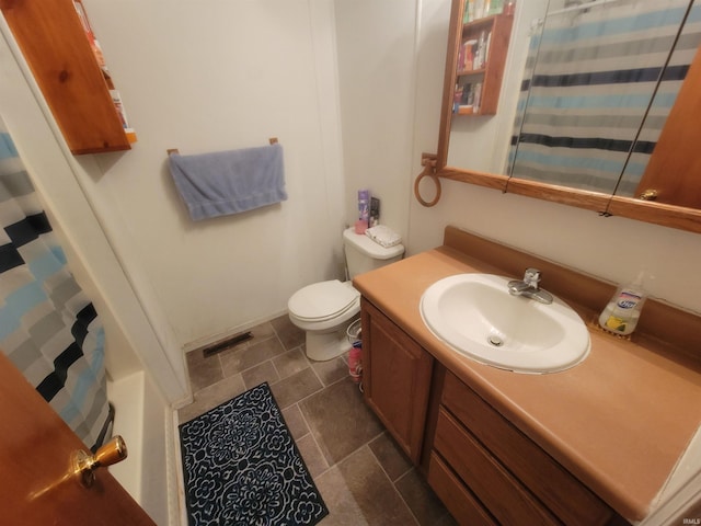 bathroom featuring vanity and toilet