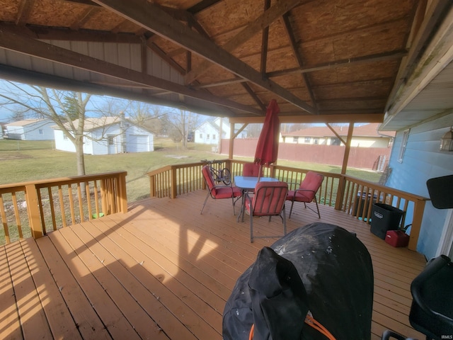 wooden terrace featuring grilling area and a lawn