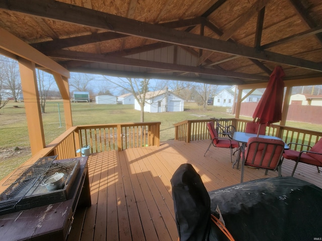 wooden terrace featuring a yard