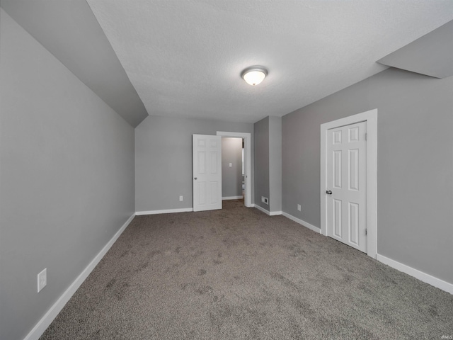 additional living space with carpet and a textured ceiling